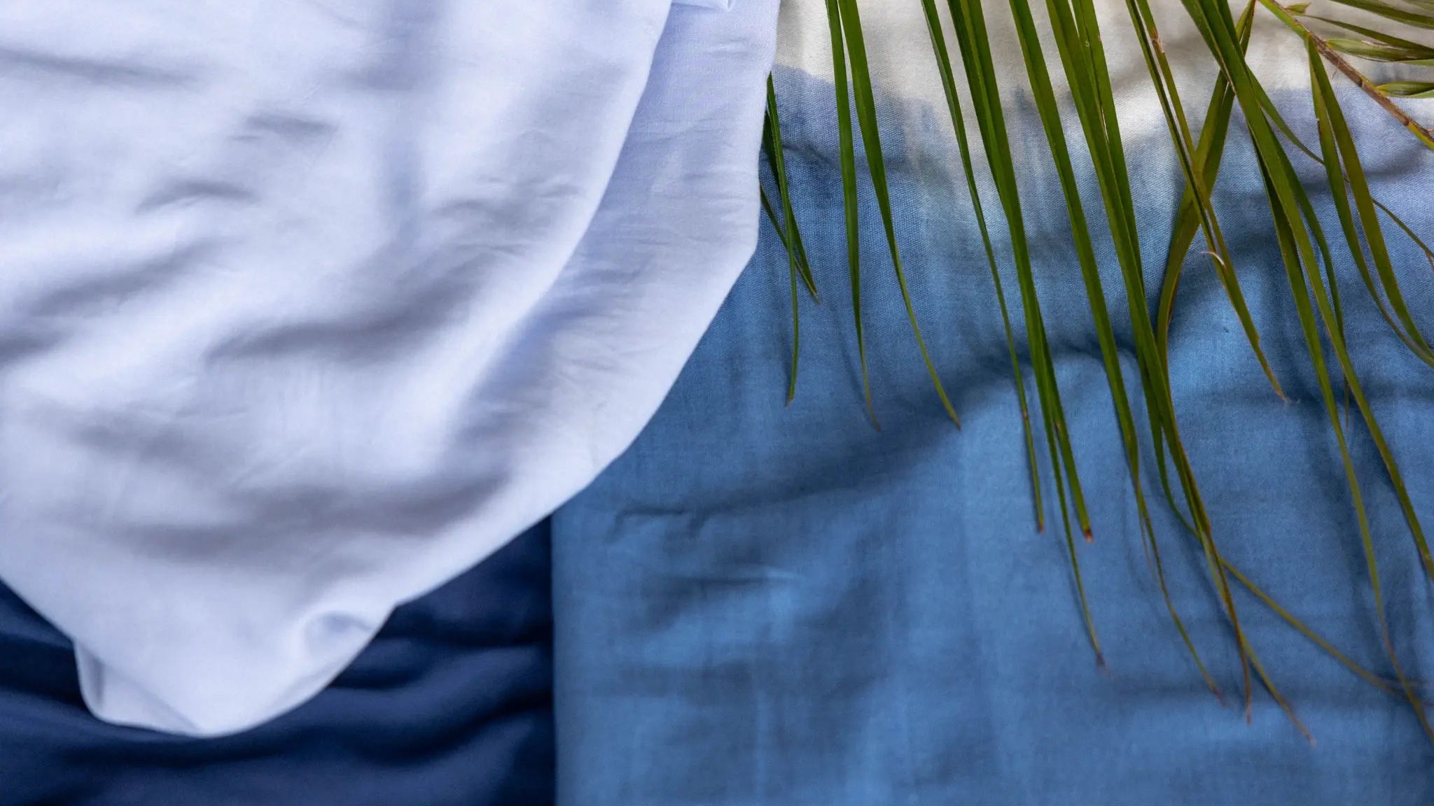 Light blue banana fiber and blue banana-cotton handloom fabric with a palm frond