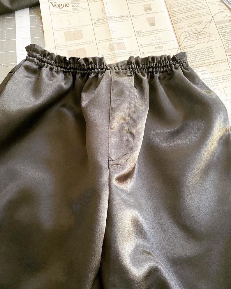 Black pants in progress with the Vogue pattern instruction sheet behind them